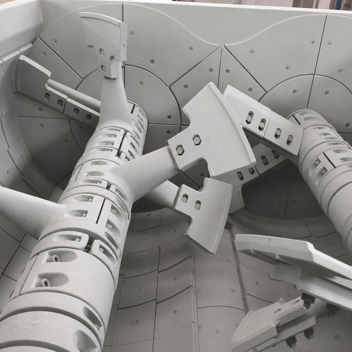 High-chromium cast alloy concrete mixer liners on an industrial manufacturing floor