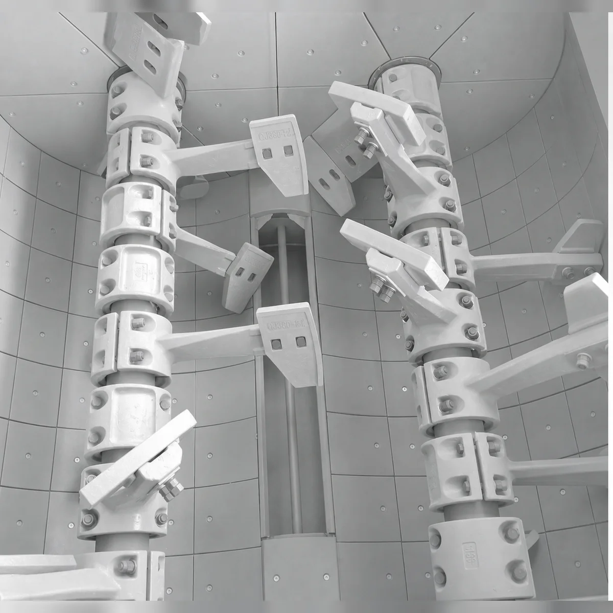 Maintenance engineer inspecting high-chromium concrete mixer liners inside a twin-shaft batching mixer