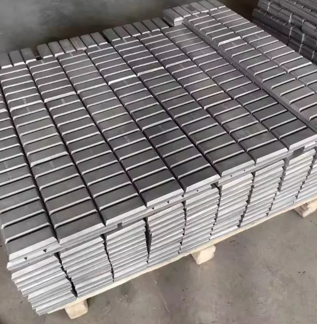 Bi-metallic chocky bars and wear buttons for excavator buckets